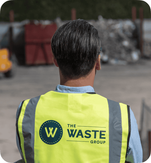 man wearing a vest with a waste group logo on the back