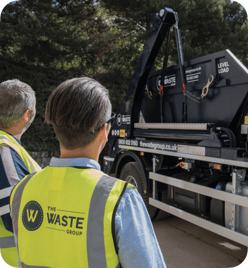 waste group employees loading a skip