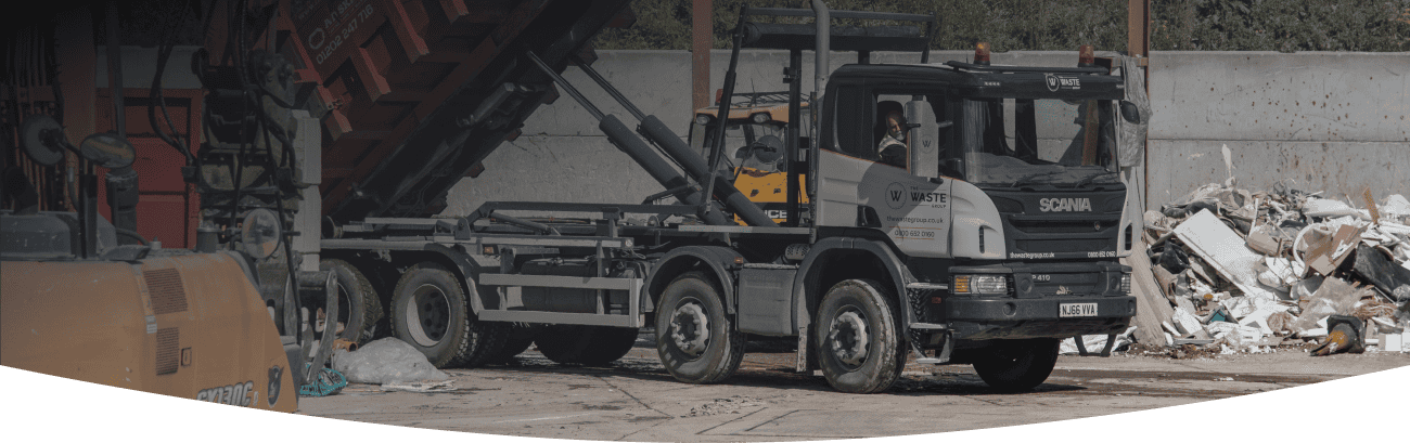 a waste group skip lorry unloading