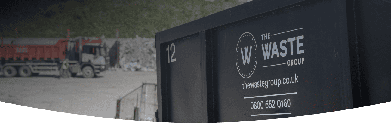a black skip with the waste group logo